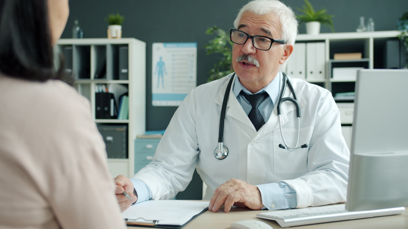A physician consulting with a patient in an office