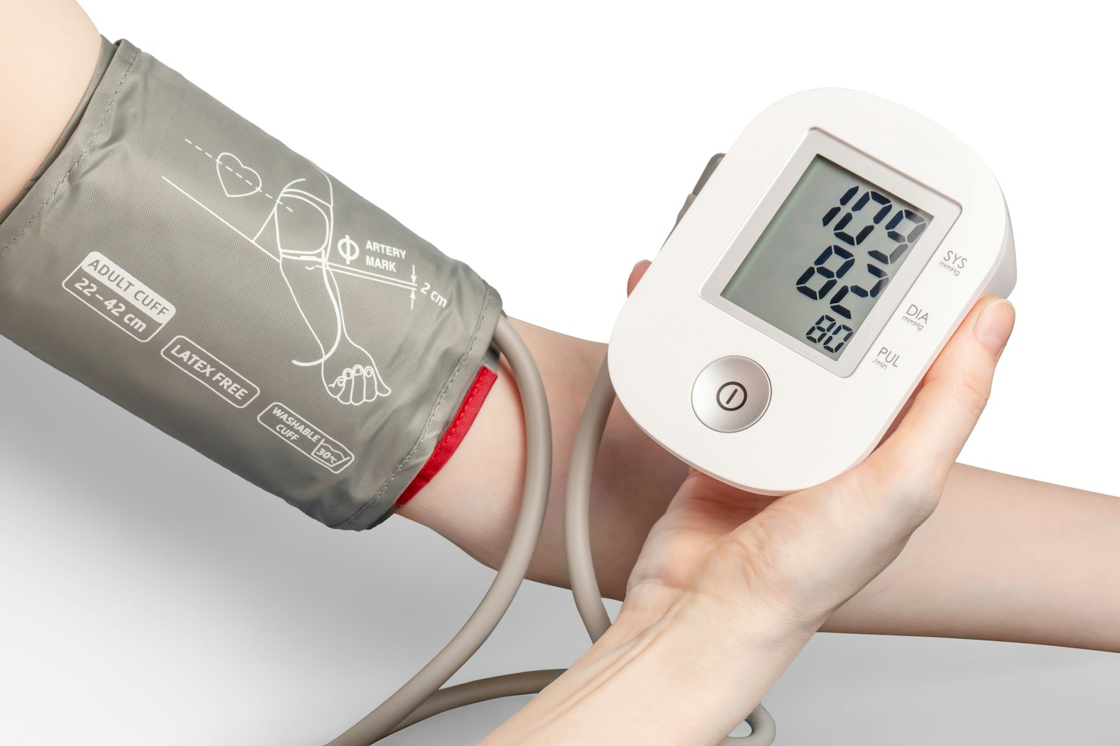 A person taking a blood pressure reading with a home monitor